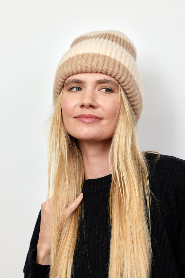 Tan and ivory striped ribbed knit cuffed beanie on model