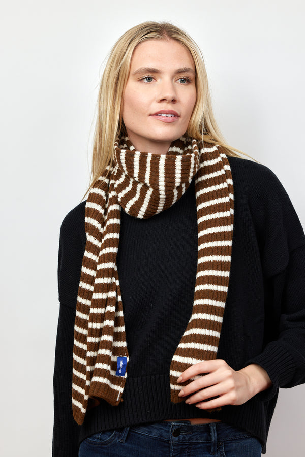 Brown and ivory ribbed striped scarf on model looking to her left