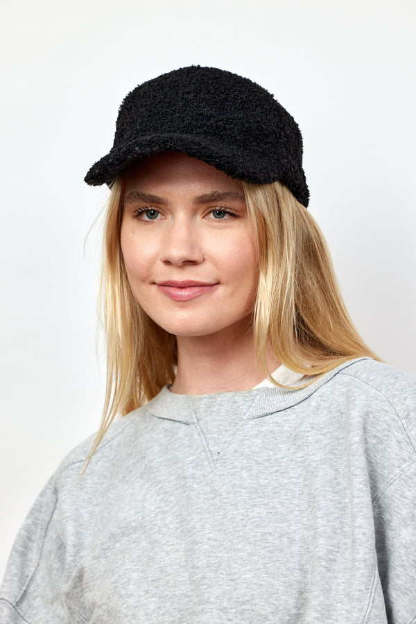 Model wearing black sherpa baseball cap