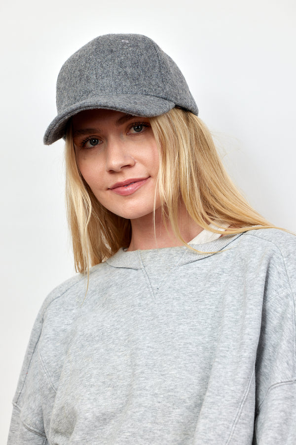 Model wearing grey wool blend baseball cap and grey sweatshirt