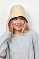 Model wearing tan knit bucket hat