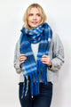 Blue and ivory plaid scarf with fringe detail on model