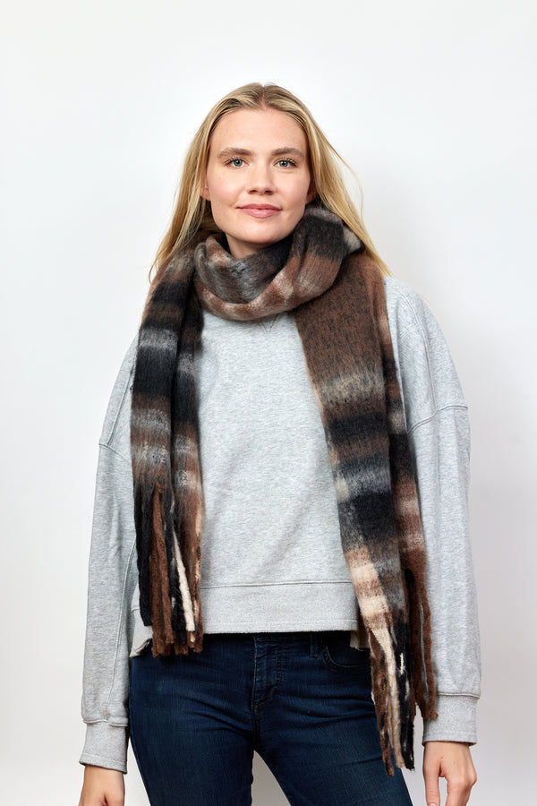 Black, brown and tan plaid scarf with fringe detail on model