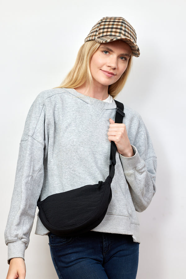 Model wearing black nylon crossbody bag