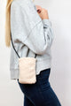 Model wearing ivory sherpa phone bag