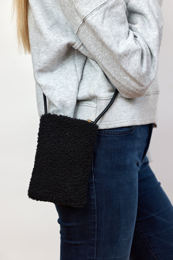 Model wearing black sherpa crossbody phone bag 