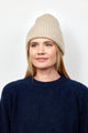 Oatmeal cashmere rib beanie on model looking to her right