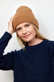 Camel brown cashmere rib beanie on model with arm raised