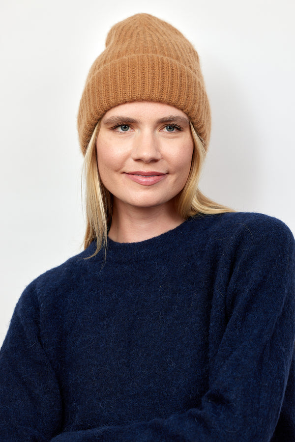 Camel brown cashmere rib beanie on model with navy sweater