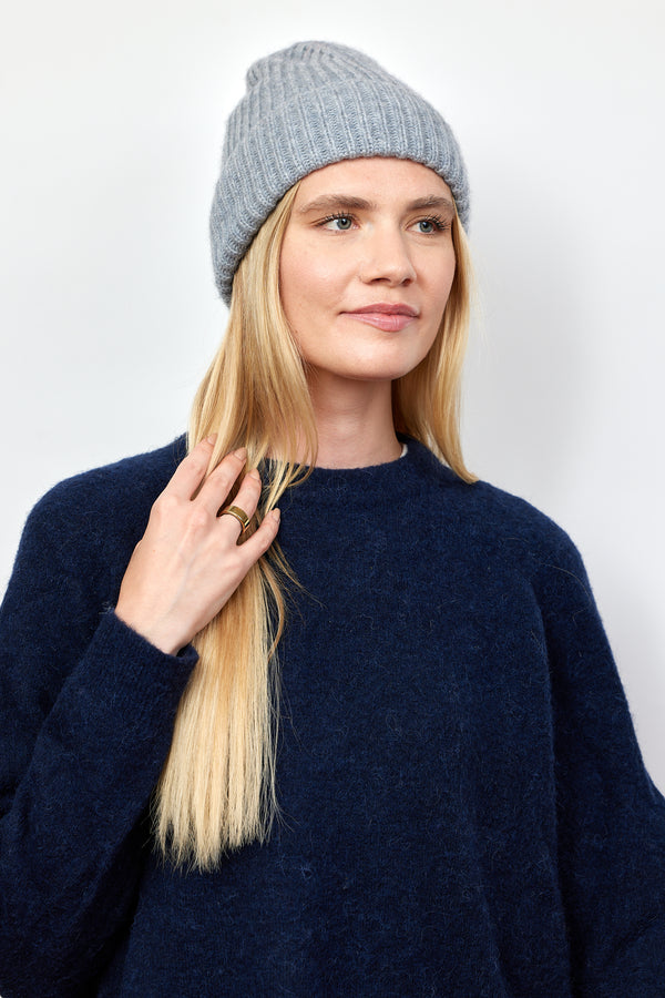 Light grey cashmere rib beanie on model with hands in her hair