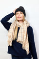 Model wearing black cashmere rib beanie and navy sweater