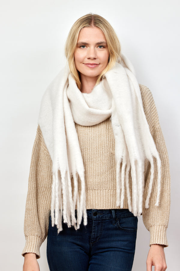 Model wearing ivory solid scarf with fringe