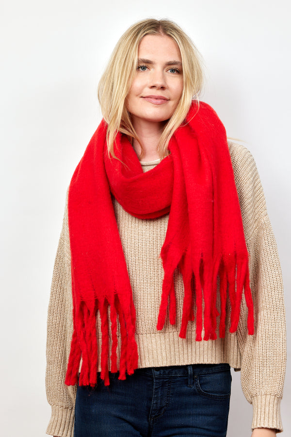 Red solid scarf with fringe on model in tan sweater