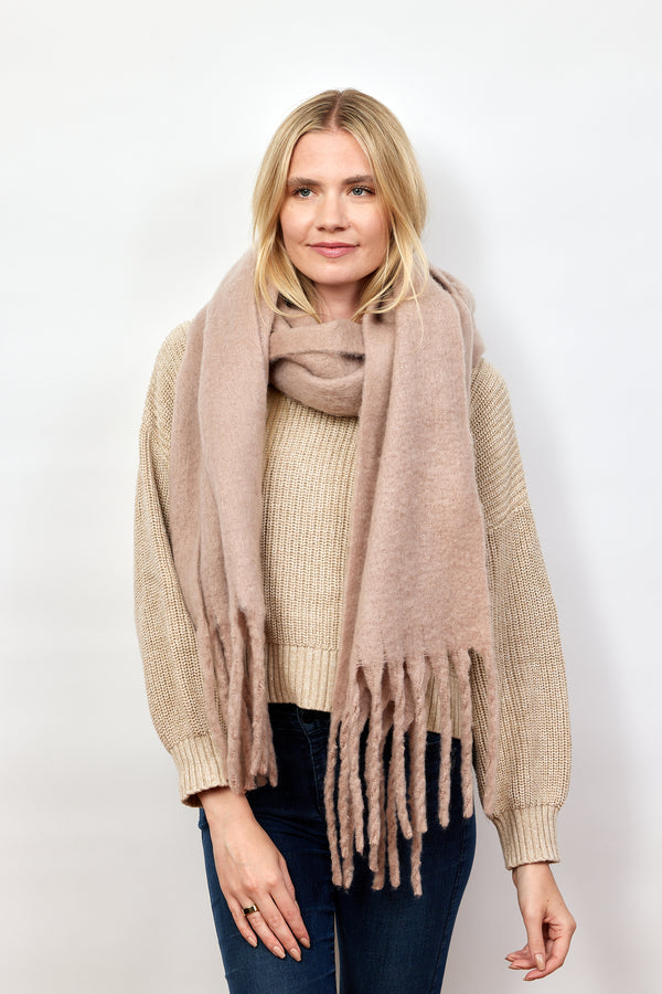 Model wearing taupe solid scarf with fringe and tan sweater