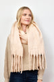 Blush pink solid scarf with fringe on model looking to her left