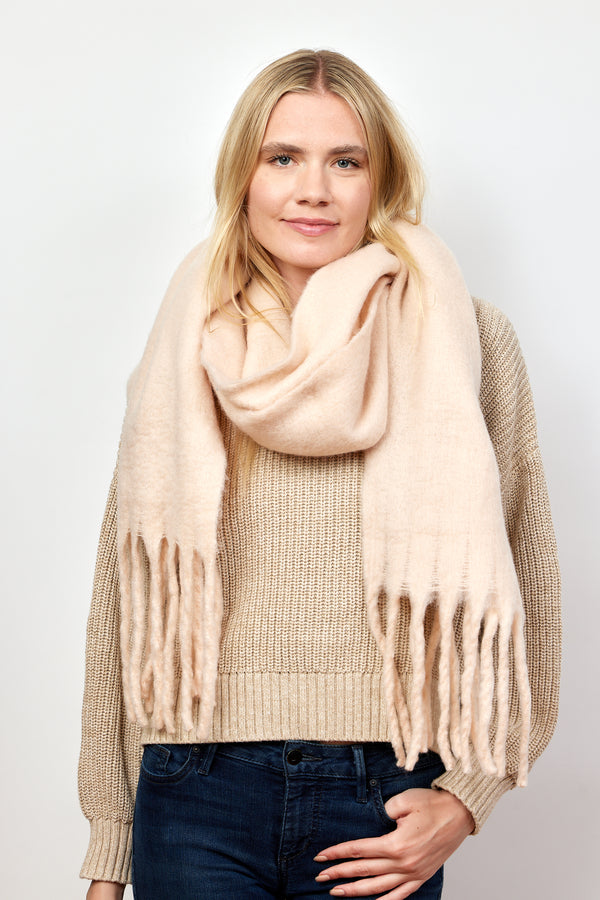 Blush pink solid scarf with fringe on model