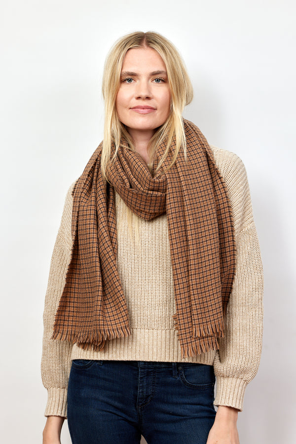 Brown and tan geometric check scarf on model in tan sweater and jeans