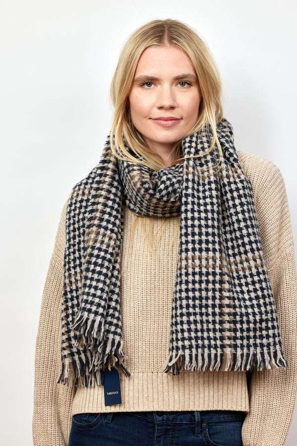 Model wearing black and tan herringbone scarf