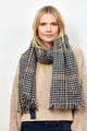 Model wearing black and tan herringbone scarf