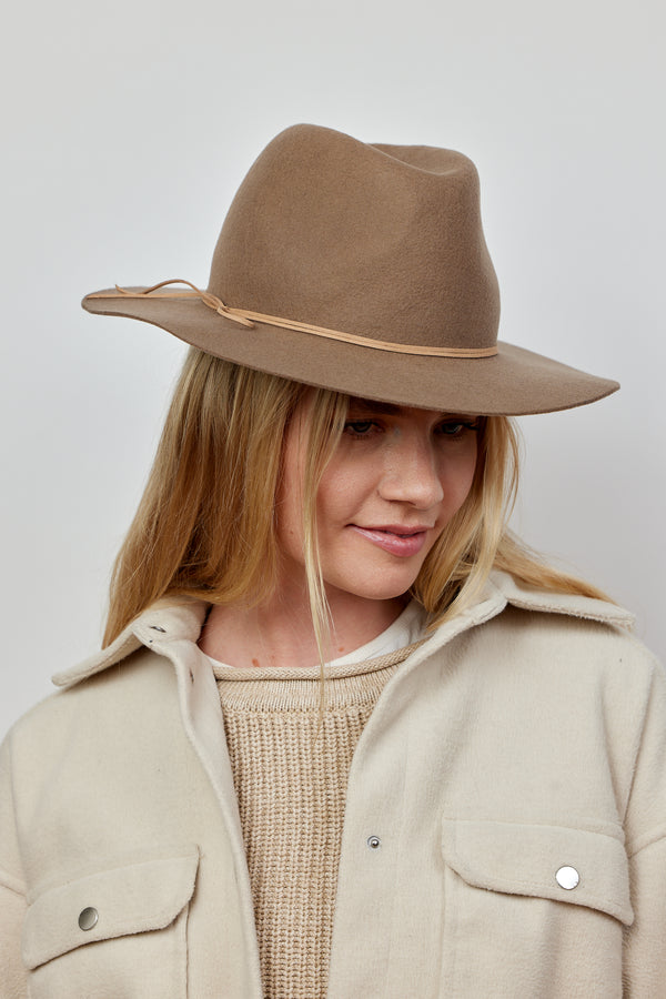 Model wearing taupe wool felt hat with tan tie