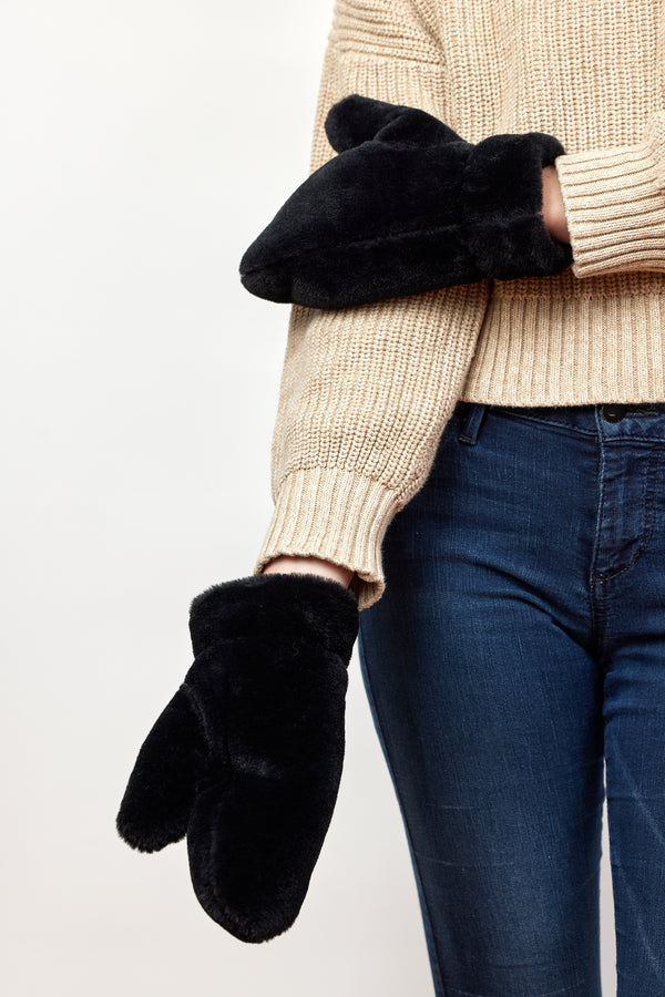 Model wearing black faux fur mittens