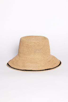 Beige straw bucket hat with black trim on a white background