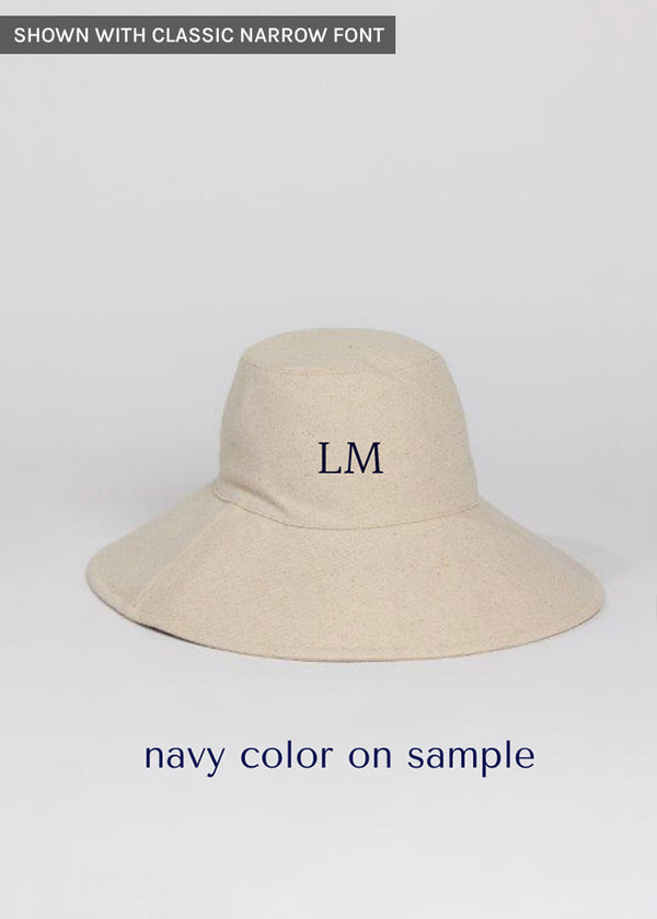 Tan sun hat with navy embroidered letters