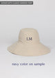 Tan sun hat with navy embroidered letters