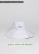 White packable sun hat with green embroidered letters