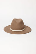 Brown fedora hat with a white band on a light beige background