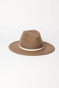 Brown fedora hat with a white band on a light gray background