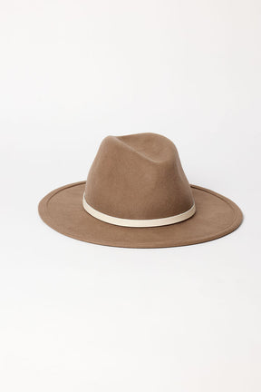 Brown fedora hat with a white band on a light gray background