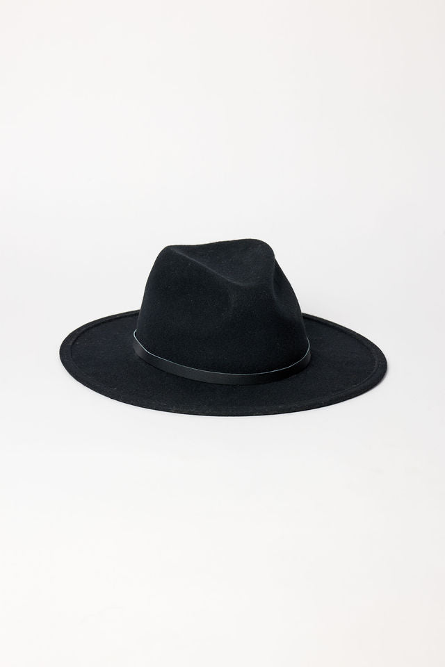 Black fedora hat on a light gray background
