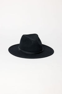 Black fedora hat on a light gray background