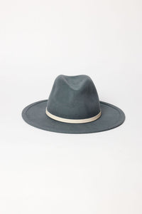 Blue fedora hat with a white band on a light gray background
