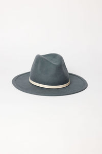 Blue fedora hat with a white band on a light gray background