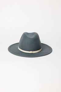 Blue fedora hat with a white band on a light gray background