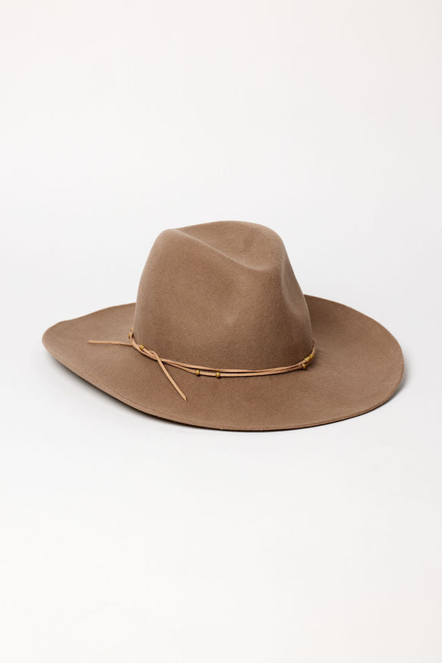 Brown felt cowboy hat with a band on a white background