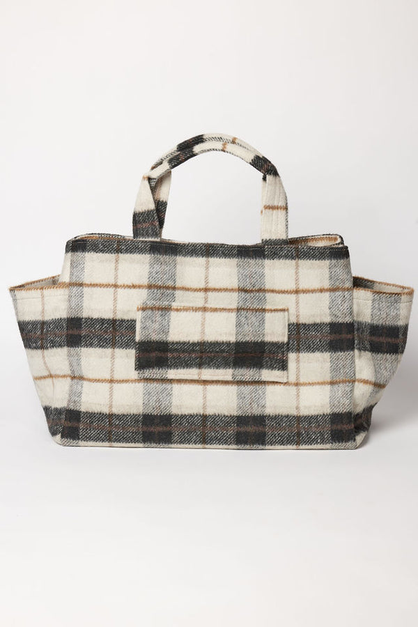 Plaid tote bag with suitcase strap on a white background