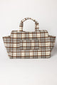 Brown and grey plaid tote bag with suitcase strap on a white background