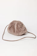3/4 angle of taupe faux fur clutch with strap