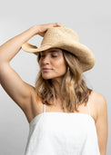 Raffia straw cowboy hat with tan wrap detail on model