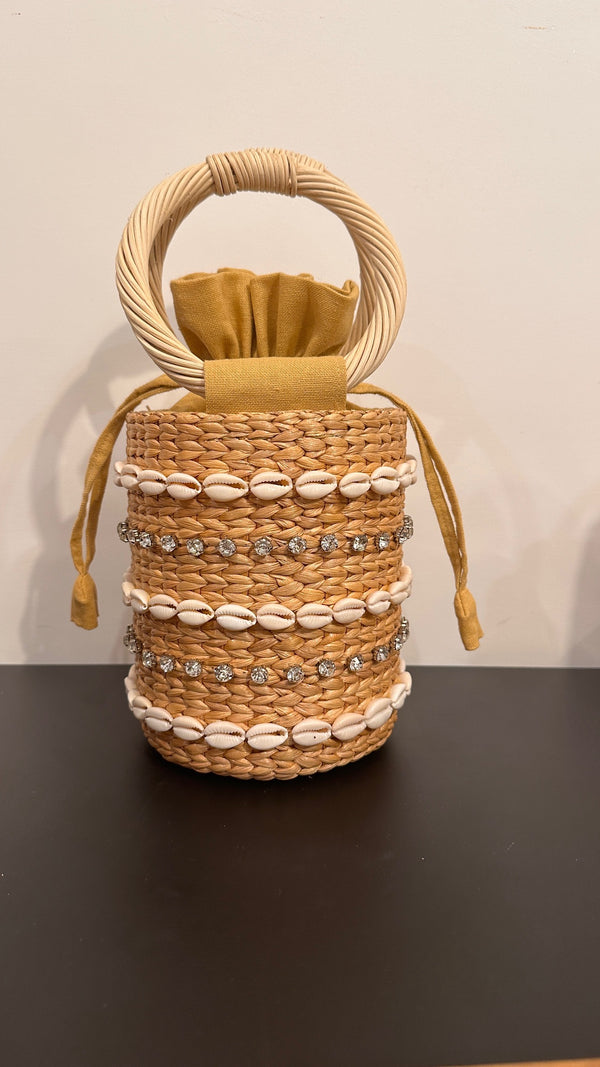 Small straw bag with round handles and embellished detail