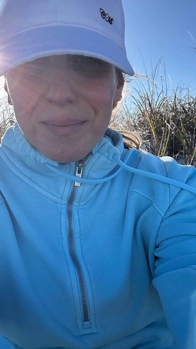 White baseball hat with embroidered letters on model