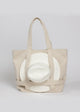 Tan canvas tote bag with white sun hat attached