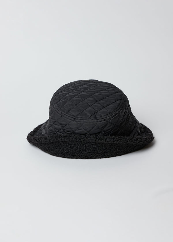 Black quilted bucket hat with faux fur lining and flipped brim