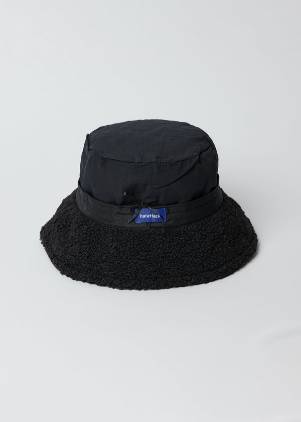 Reverse of black quilted bucket hat with faux fur lining