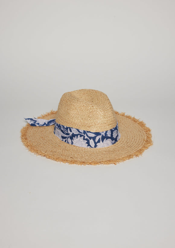 Straw hat with fringe detail on brim and blue floral fabric trim