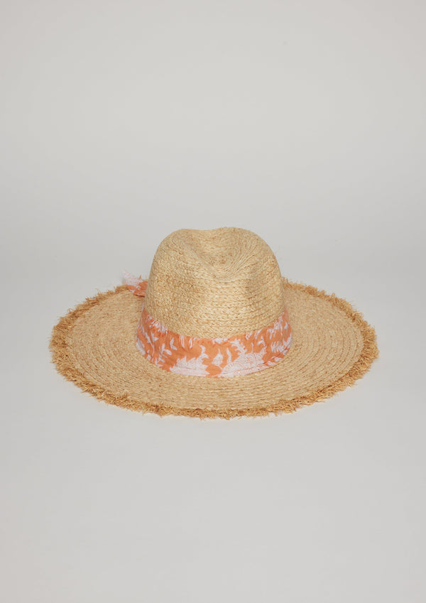 Front view of straw hat with fringe detail on brim and orange floral fabric trim