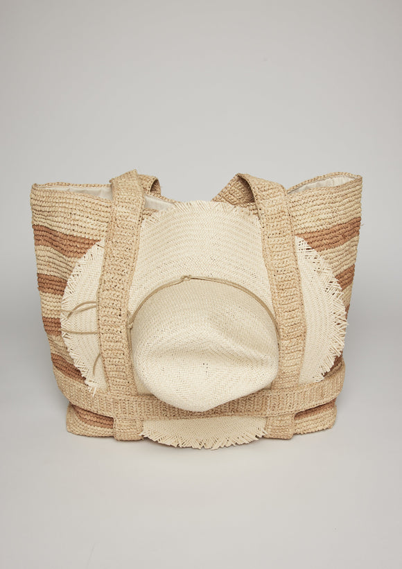 Tan stripe beach tote with fringe brimmed sun hat attached with straps